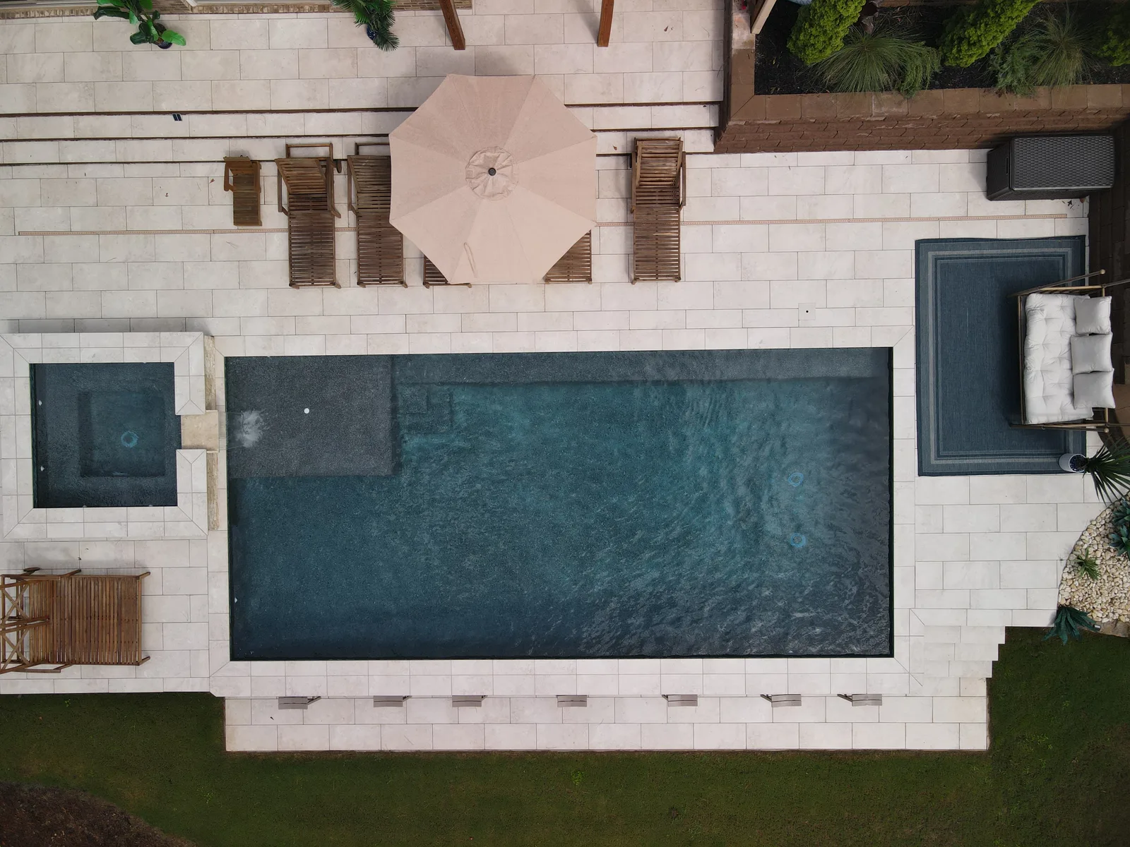 Drone view of a RutherfordMade pool and patio filling an established North Metro Atlanta backyard