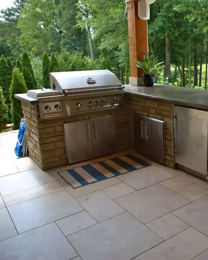 Acworth RutherfordMade outdoor kitchen with built-in grill, refrigerator, stonework, and pool view