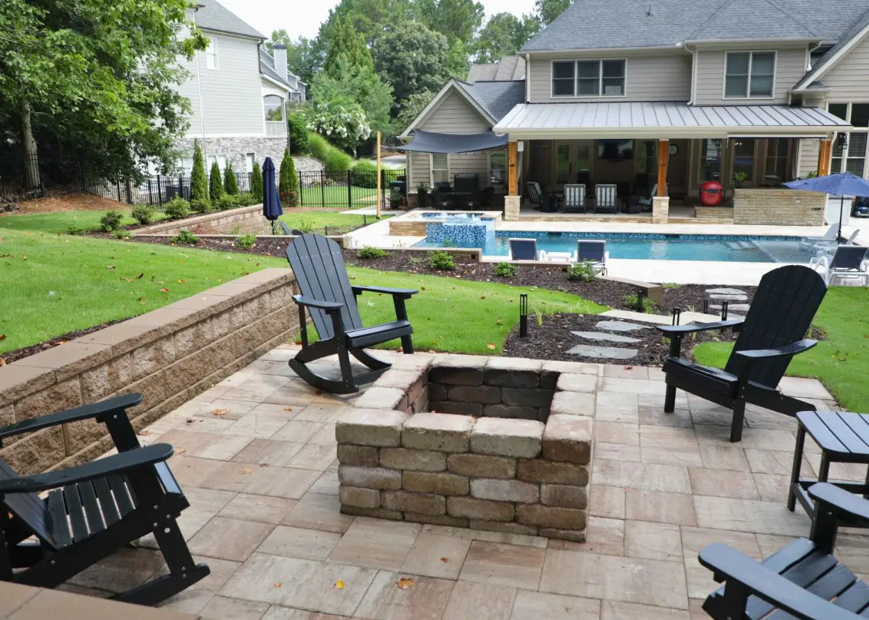 Acworth RutherfordMade paver patio, fire pit, pool, lighting, and outdoor living layout