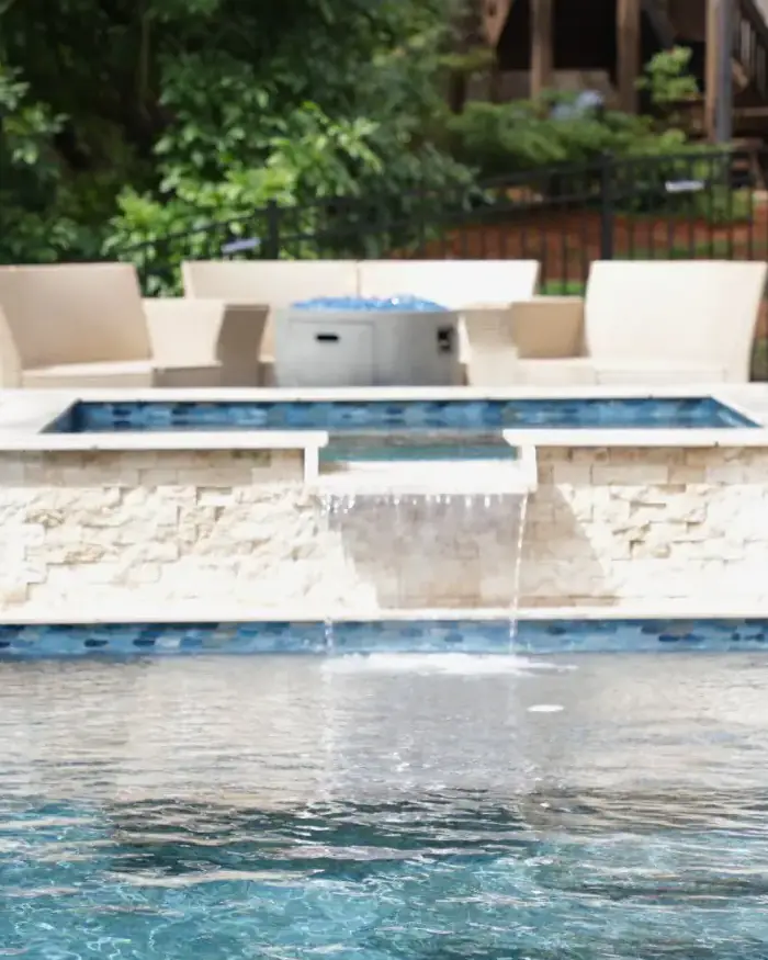 RutherfordMade raised spa spillover connected to a custom pool